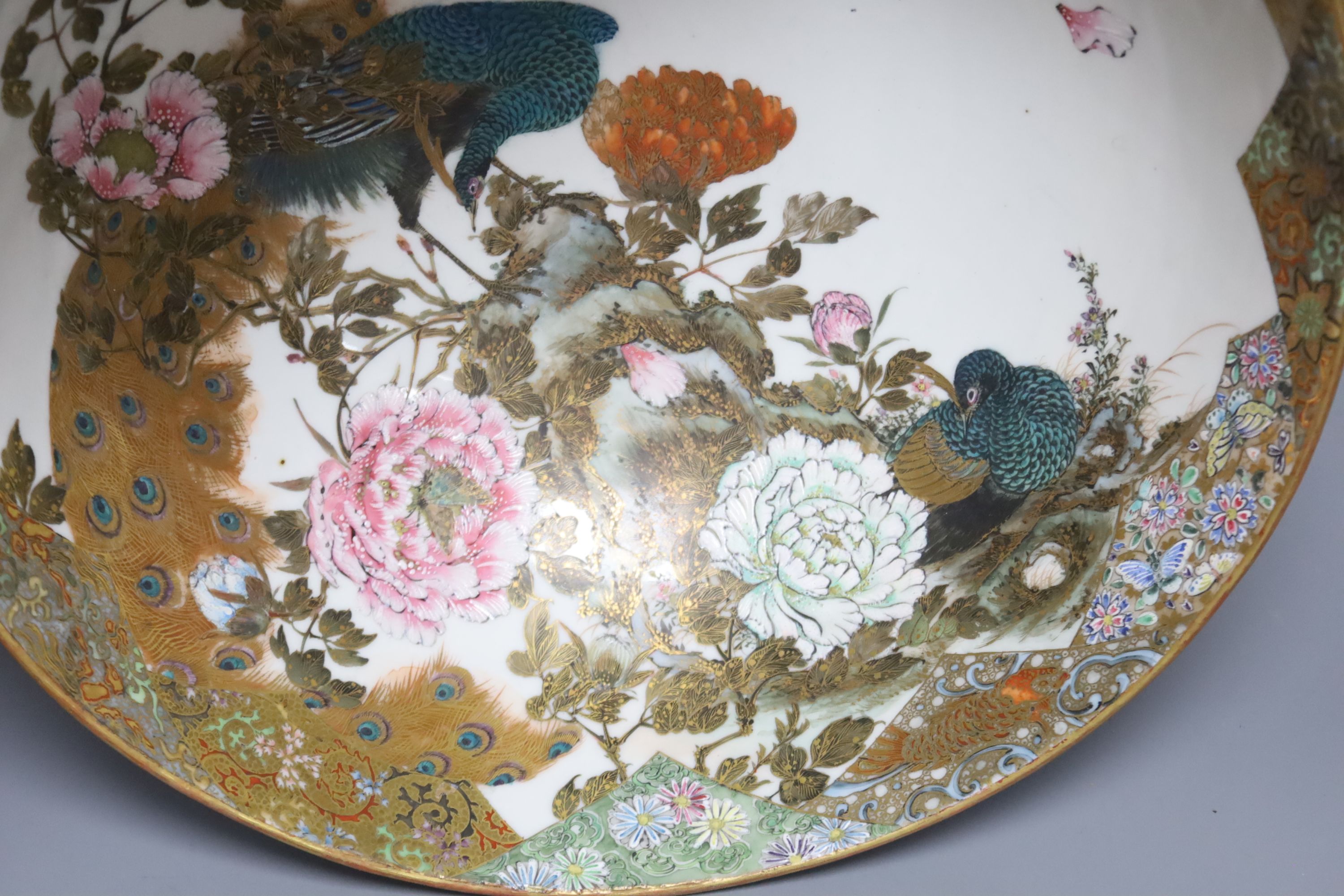 A large early 20th century Japanese Kutani bowl, painted with peacocks and flowers, 13cm high, 31cm diam